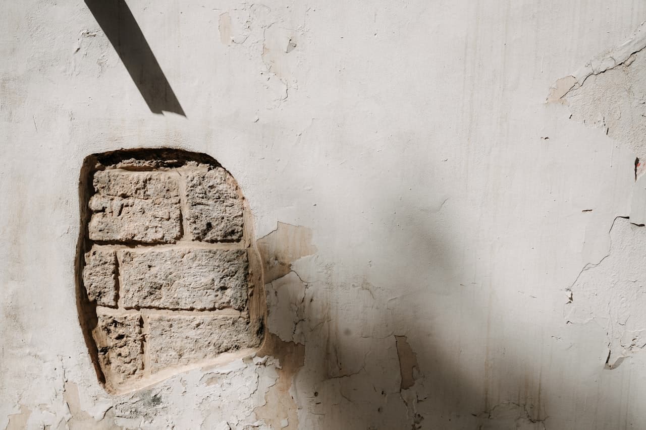 Briques exposées à travers un trou dans un mur